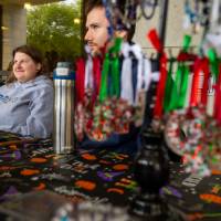 Students working a booth displaying bracelets during Student Small Business Market.